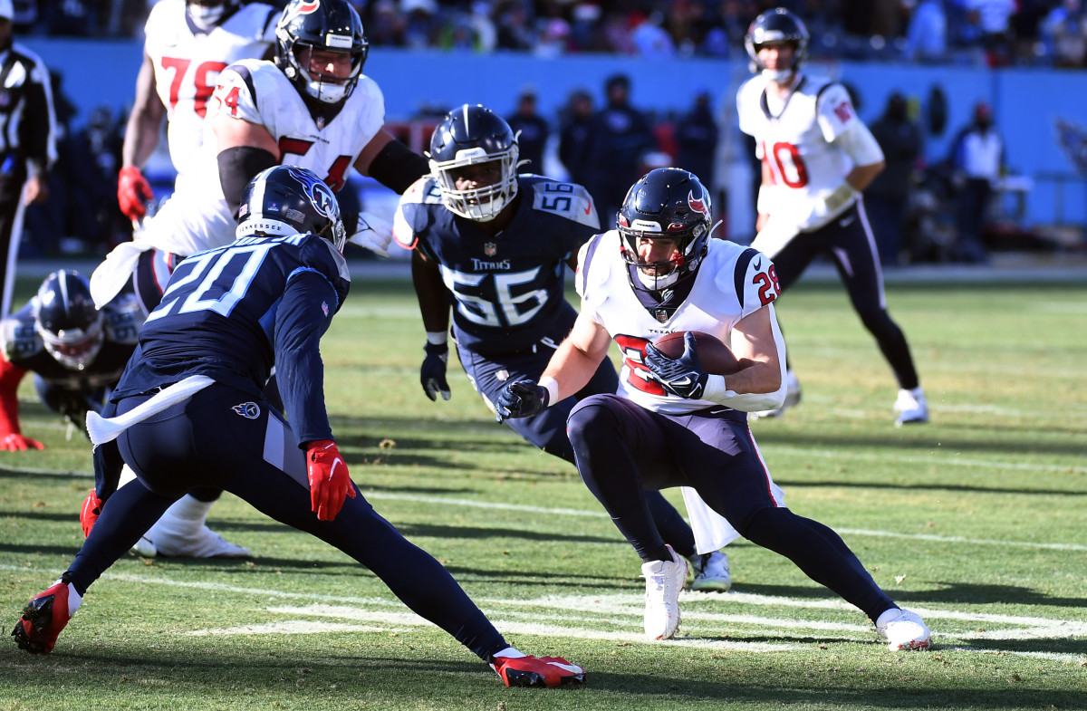 Houston Texans running back Rex Burkhead runs while Titans players set up to tackle him